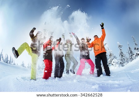 Group of friends snowboarders having fun on the top of mountain in Sheregesh resort