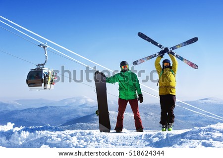 Snowboarder and skier on mountain against ski lift