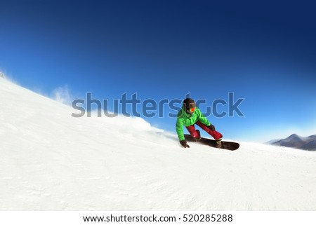 Man snowboarder rides on the slope. ski resort. Space for text