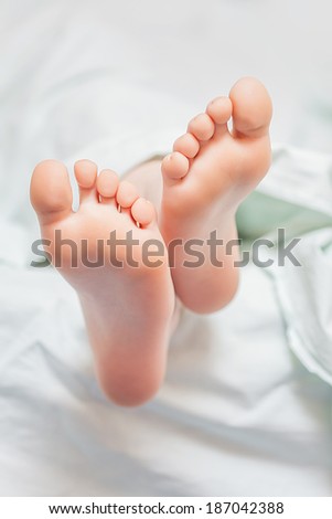 Beautiful young feet with body cream
