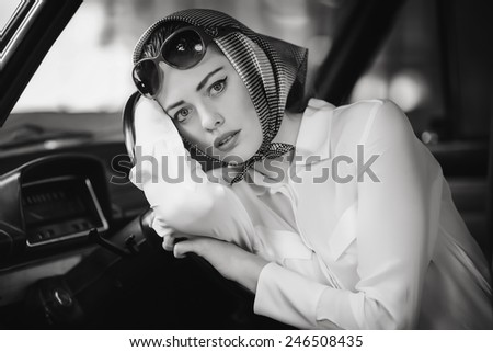 girl sitting wheel of a car