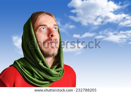 the look of a man with his head covered up at the sky, hoping to see something