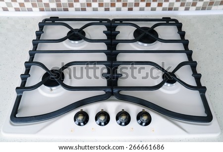Cooking on a modern design gas stove burner - kitchen tools details