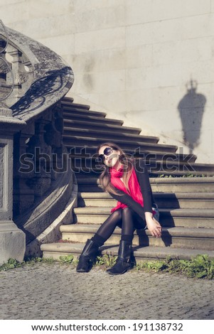 Young Pretty Woman Sitting on Stairs on a Sunny Day