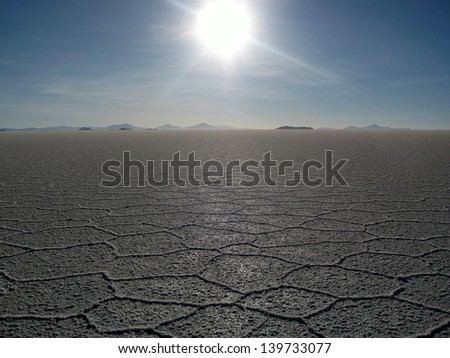 SALT FLATS, BOLIVIA - CIRCA 2008 - Sun sets towards the horizon, casting shadows across the crystal formations on the salt flats
