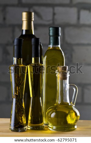 Olive oil bottle still-life over grey  background