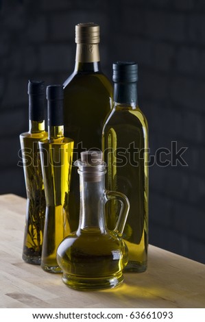 Olive oil bottle still-life over dark  background