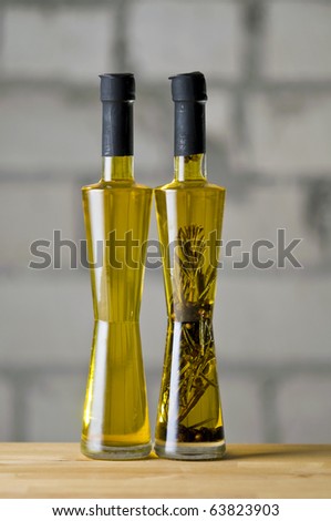 Olive oil bottle still-life over grey  background