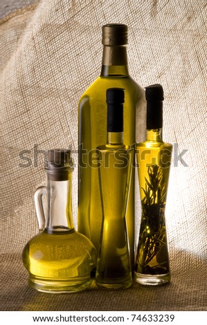 Olive oil bottle still-life over  textured background with back light