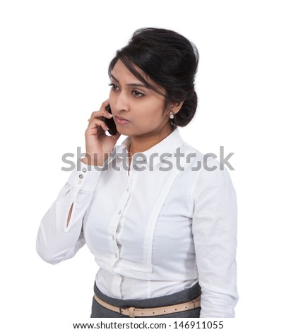 Side view of a sad Asian businesswoman talking on cell phone