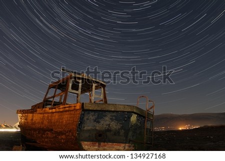 Star trails over a boat, Ireland