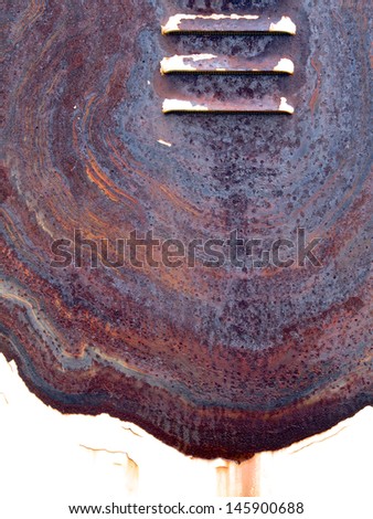Intricate colorful rust patter on a painted surface in need of repair, with vents