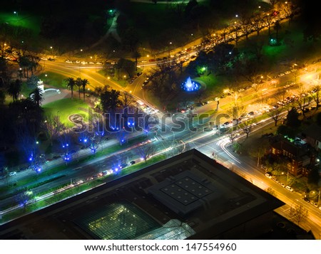 night view of melbourne city street intersection from above showing fountain lit by blue lights