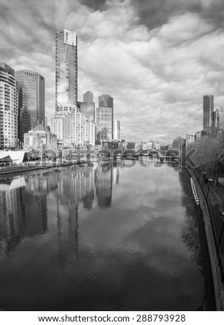 black and white melbourne reflected in the yarra river on a cold winter day