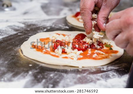 Italian chef preparing a pizza