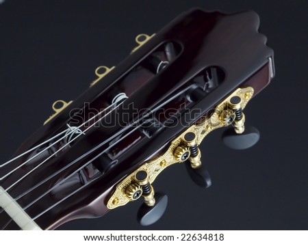 Details of a guitar head on black background