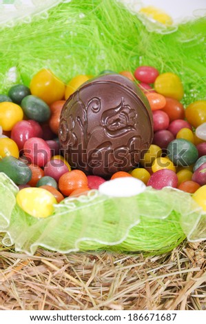 Colorful easter eggs and chocolate egg in a basket
