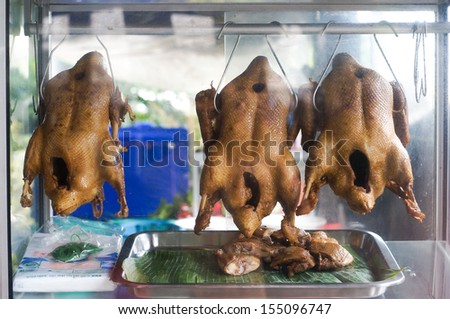 The steamed ducks with soy sauce are hanging in the cupboard