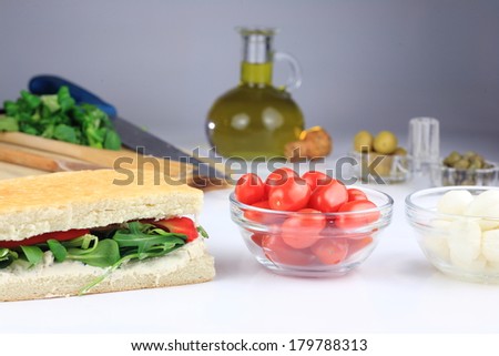 sandwiches with salad and cold meat and seasoned with olive oil and capers