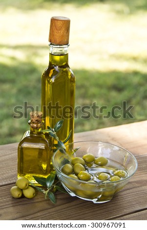 olives and olive oil in the garden table