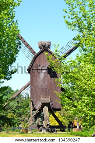Stork nest on a mill - Photo of a nest of storks on the top of a flour mill