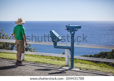 Man watching the ocean from the lookout