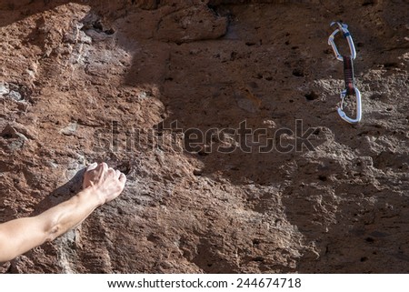 Hand climbing on rock wall