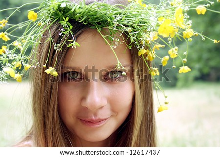 Beautiful young woman wearing a flower diadem.