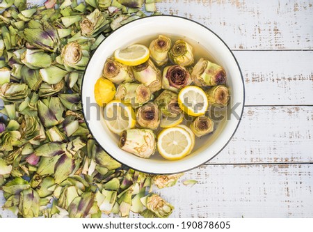 Artichoke heart in water and lemon bowl