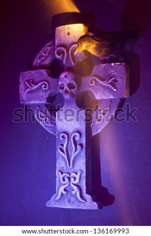 Gothic Cross and raven in colorful lighting