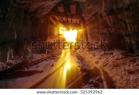 Gold Mine entrance with beams of light streaming in.