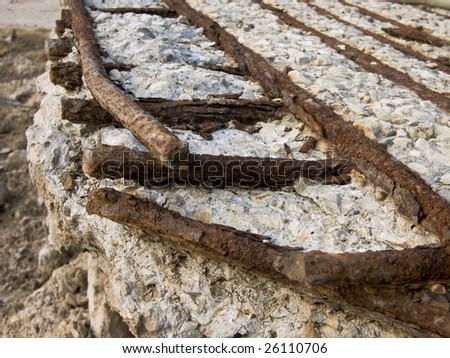 stock photo Rusty reinforcement rods in the crushed concrete slab