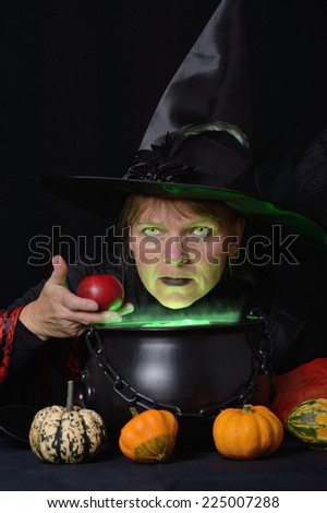 witch with red apple and cauldron total vertical format