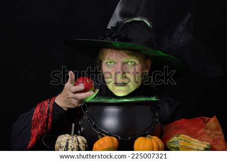 witch with red apple and cauldron total view