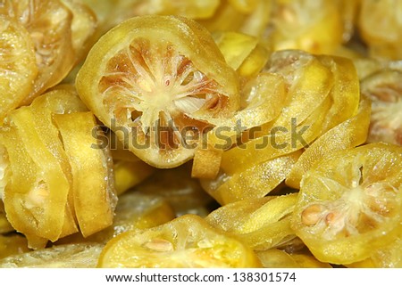 Slices of dried lemons in sugar background