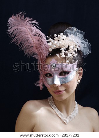 Young lady in fancy mask with pearl necklace