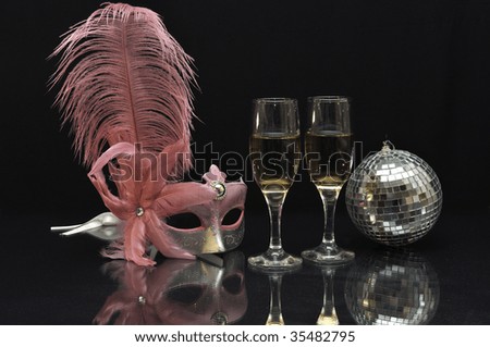 Pink mask with wine glasses and a mirror ball on black