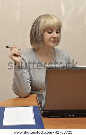 Lady at the moment of creating activity with laptop at the office table.