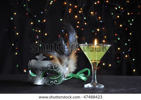 Green fancy mask with candle and blinking lights on black