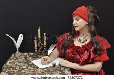 Charming lady in red antique dress writing a letter