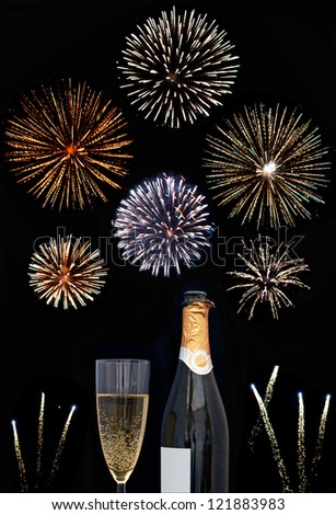 Firework display around a champagne glass and bottle