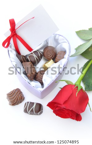 Heart shaped chocolate gift with red rose