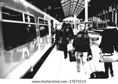 Passengers boarding a train at a city station