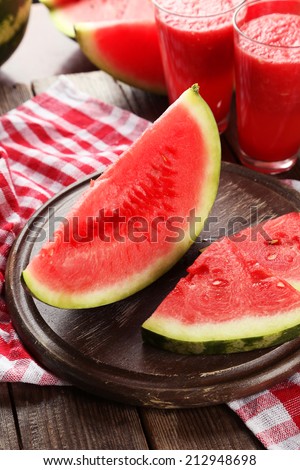 Slices of watermelon on brown wooden background