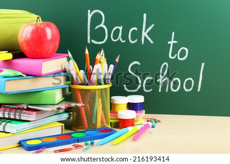 Back to school supplies. Books and blackboard.