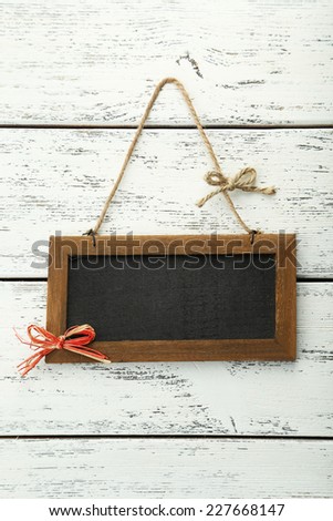 Brown wooden frame on white wooden background
