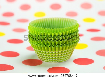 Empty cupcake cases on colorful background