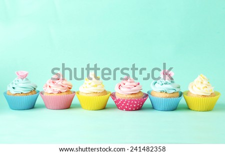 Birthday cupcakes on green background