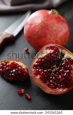 Delicious pomegranate fruit on black background