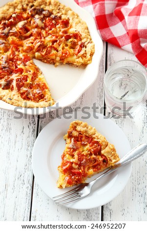 Fresh tomato pie on white wooden background